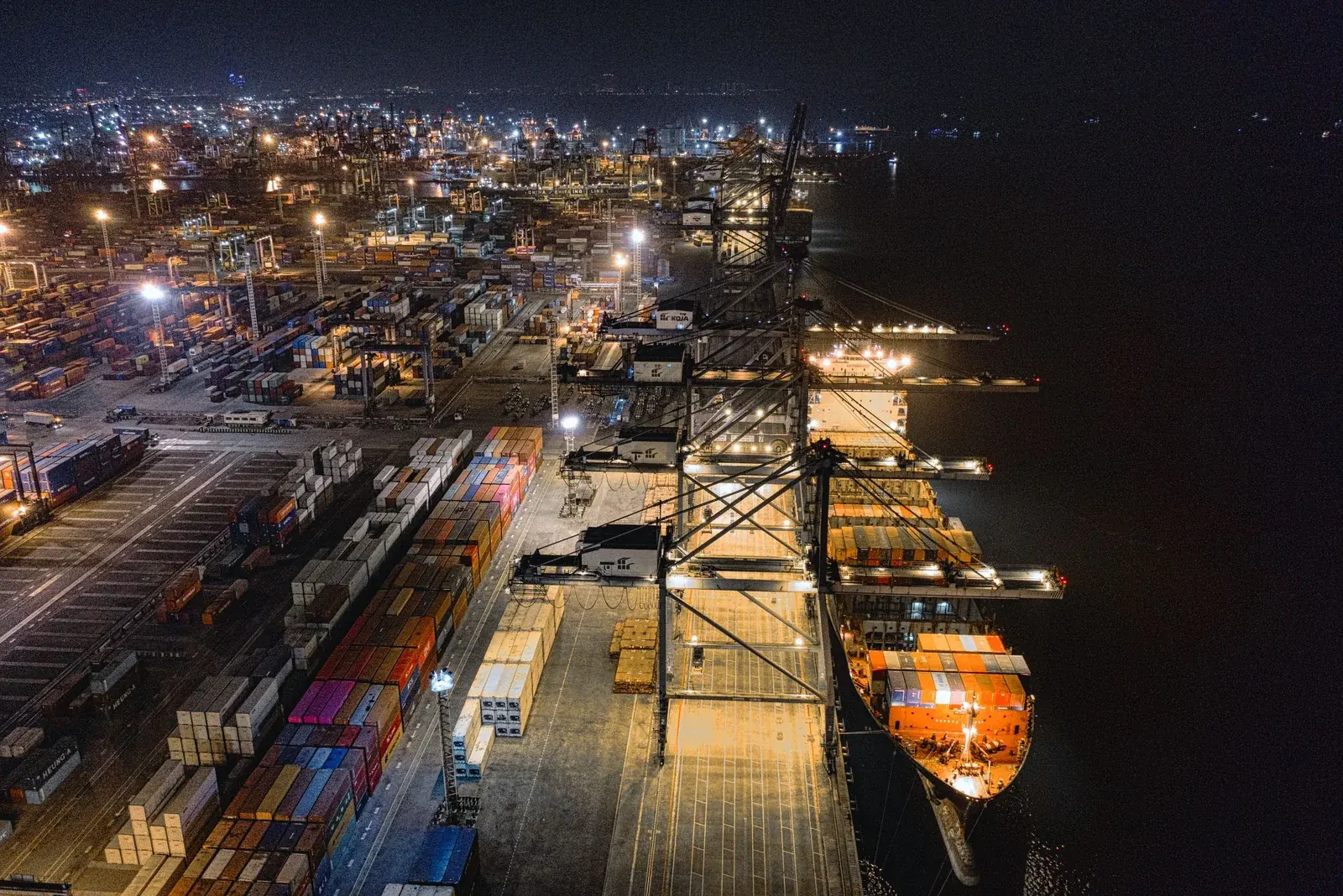 Illuminated freight port and logistics operations at night