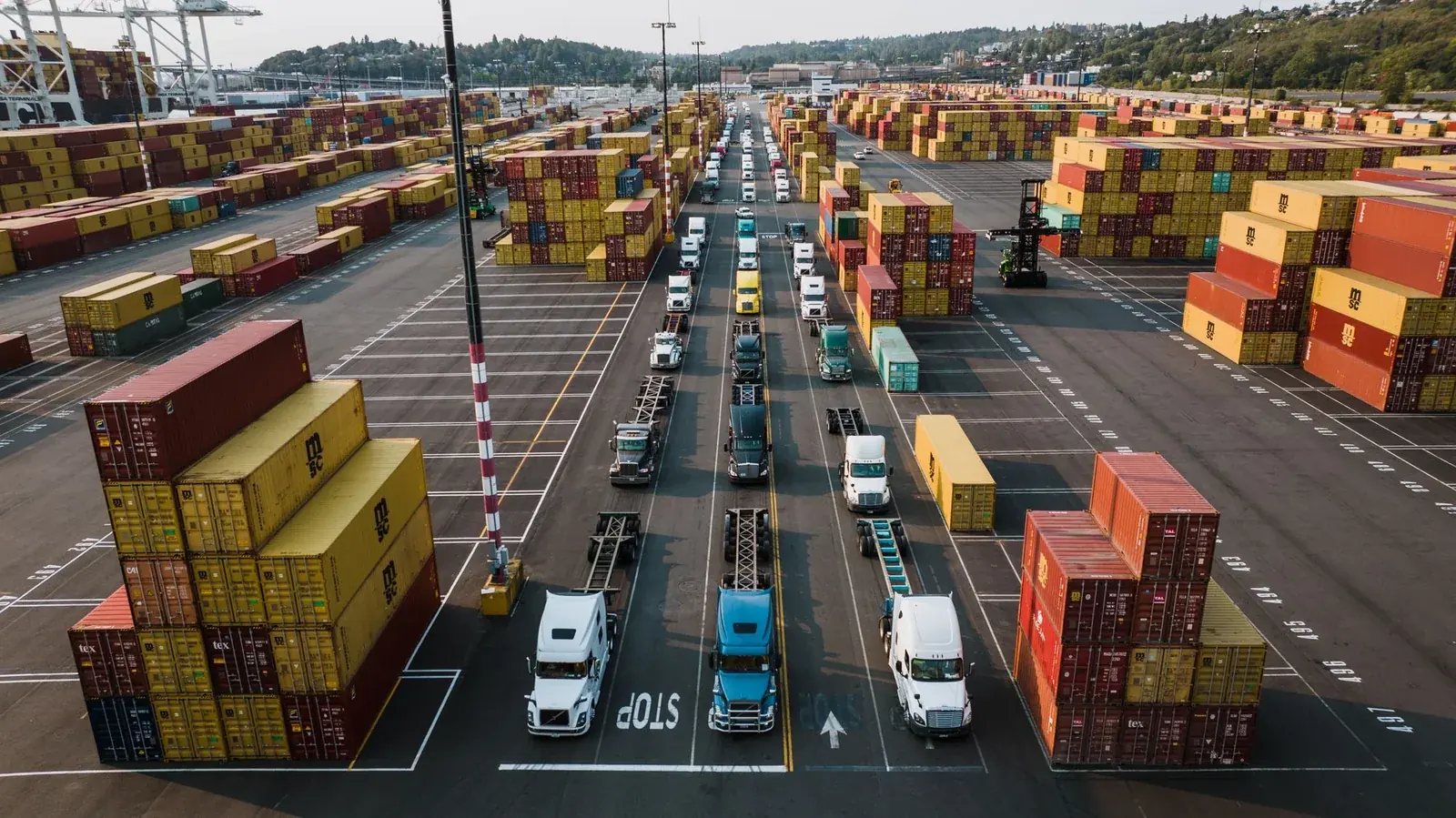 Freight trucks and cargo containers at a logistics terminal